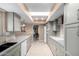 Modern kitchen with gray cabinets and granite countertops at 17811 N Boswell Blvd, Sun City, AZ 85373