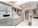 Bright kitchen with gray cabinets, an island, and tile backsplash at 17811 N Boswell Blvd, Sun City, AZ 85373