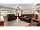 Relaxing living room featuring brown leather sofas and tile flooring at 17811 N Boswell Blvd, Sun City, AZ 85373