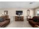 Living room featuring a large TV and comfortable seating at 17811 N Boswell Blvd, Sun City, AZ 85373