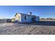 Side view of a single-story house with a car parked in the driveway at 1826 S 363Rd Ave, Tonopah, AZ 85354