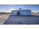 Rear view of a single-story house with a small tree and spacious yard at 1826 S 363Rd Ave, Tonopah, AZ 85354