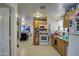 Simple kitchen featuring wood cabinets, white appliances, and tiled floors at 1826 S 363Rd Ave, Tonopah, AZ 85354