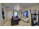 Living room with dark gray couch and a large flat-screen TV at 1826 S 363Rd Ave, Tonopah, AZ 85354