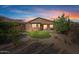 Landscaped backyard with patio and lawn at sunset at 18311 E San Ignacio Ct, Gold Canyon, AZ 85118