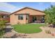 Artificial turf lawn, covered patio, and desert landscaping in backyard at 18311 E San Ignacio Ct, Gold Canyon, AZ 85118