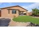 Landscaped backyard with curved lawn and rock border at 18311 E San Ignacio Ct, Gold Canyon, AZ 85118