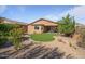 Landscaped backyard with artificial turf and desert landscaping at 18311 E San Ignacio Ct, Gold Canyon, AZ 85118