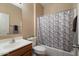 Neat bathroom with a single sink vanity and hexagonal shower curtain at 18311 E San Ignacio Ct, Gold Canyon, AZ 85118