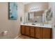 Double vanity bathroom with a large mirror and stylish light fixtures at 18311 E San Ignacio Ct, Gold Canyon, AZ 85118