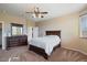 Bright bedroom featuring a ceiling fan and ample closet space at 18311 E San Ignacio Ct, Gold Canyon, AZ 85118