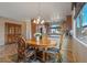 Bright dining area with wood table and chairs, adjacent to kitchen at 18311 E San Ignacio Ct, Gold Canyon, AZ 85118