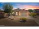 Single-story house with desert landscaping and two-car garage at sunset at 18311 E San Ignacio Ct, Gold Canyon, AZ 85118