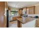 Kitchen boasts stainless steel appliances and ample wood cabinetry at 18311 E San Ignacio Ct, Gold Canyon, AZ 85118