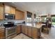 Open kitchen with island, stainless steel appliances, and wood cabinets at 18311 E San Ignacio Ct, Gold Canyon, AZ 85118