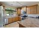 Modern kitchen with stainless steel appliances and wood cabinets at 18311 E San Ignacio Ct, Gold Canyon, AZ 85118