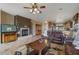 Living room with fireplace, leather couches, and a view into the kitchen at 18311 E San Ignacio Ct, Gold Canyon, AZ 85118