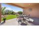 Covered patio with seating area overlooking a grassy backyard at 18311 E San Ignacio Ct, Gold Canyon, AZ 85118