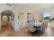 Elegant dining room features a large table, hardwood floors, and a view to the backyard at 18702 E Gemmill Dr, Rio Verde, AZ 85263