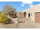 Front entry of a beautiful Southwestern-style home with gated courtyard at 18702 E Gemmill Dr, Rio Verde, AZ 85263