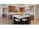 Gourmet kitchen with granite countertops, wooden cabinets, and a large island at 18702 E Gemmill Dr, Rio Verde, AZ 85263