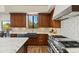 Modern kitchen with farmhouse sink, stainless steel appliances, and wooden cabinets at 18702 E Gemmill Dr, Rio Verde, AZ 85263