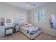 Bright bedroom features white furniture, a stylish floral bedspread, and a vanity with illuminated mirror at 1918 W Bonanza Ln, Phoenix, AZ 85085