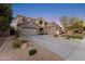 Two-story house with gray exterior, landscaped yard, and a three-car garage at 1918 W Bonanza Ln, Phoenix, AZ 85085