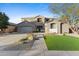 Two-story house with gray exterior, landscaped yard, and a three-car garage at 1918 W Bonanza Ln, Phoenix, AZ 85085