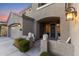 Inviting front entrance with a dark gray door, flanked by planters and white chairs at 1918 W Bonanza Ln, Phoenix, AZ 85085