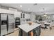 White kitchen with island, stainless steel appliances, and view into Gathering room at 1918 W Bonanza Ln, Phoenix, AZ 85085