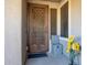 Front entry with decorative metal door and sunflowers at 2052 N Montclair Ln, Casa Grande, AZ 85122