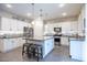 Modern kitchen with white cabinets, granite countertops, and large island at 2052 N Montclair Ln, Casa Grande, AZ 85122