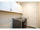 Well-appointed laundry room with washer, dryer, and ample cabinetry at 2052 N Montclair Ln, Casa Grande, AZ 85122