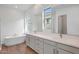 Modern bathroom with double vanity, freestanding tub, and wood-look tile flooring at 22663 E Happy Rd, Queen Creek, AZ 85142