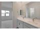 Bathroom with double sinks, a large mirror, and access to bedroom and shower/tub at 22663 E Happy Rd, Queen Creek, AZ 85142