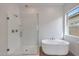 Bathroom featuring glass shower, soaking tub and natural light at 22663 E Happy Rd, Queen Creek, AZ 85142