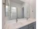 Bathroom featuring double sinks, gray cabinetry and a large mirror at 22663 E Happy Rd, Queen Creek, AZ 85142