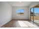 A bright bedroom featuring tile flooring, a large window and sliding glass door at 22663 E Happy Rd, Queen Creek, AZ 85142