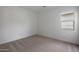 Bedroom with neutral carpet and a window providing natural light at 22663 E Happy Rd, Queen Creek, AZ 85142