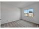 Bright bedroom with neutral carpet, a window providing natural light, and ample space at 22663 E Happy Rd, Queen Creek, AZ 85142