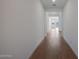 Inviting hallway with wood-look floors and bright, neutral walls leading to the home's interior at 22663 E Happy Rd, Queen Creek, AZ 85142