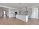 Modern kitchen featuring a large island, stainless hood, and tile backsplash at 22663 E Happy Rd, Queen Creek, AZ 85142