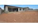 Exterior view of the backyard with a dirt area and patio at 22670 E Happy Rd, Queen Creek, AZ 85142