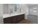 Bathroom featuring dual sinks, a vanity, a toilet, and wood look floors at 22670 E Happy Rd, Queen Creek, AZ 85142