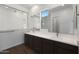 Bright bathroom featuring a large vanity with dual sinks and a large mirror with windows at 22670 E Happy Rd, Queen Creek, AZ 85142