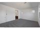 Bright bedroom features neutral carpet, white walls, and a glimpse into the connected bathroom at 22670 E Happy Rd, Queen Creek, AZ 85142