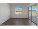 Neutral bedroom featuring hard floors, a sliding glass door, and a bright window at 22670 E Happy Rd, Queen Creek, AZ 85142