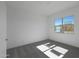 Bright bedroom featuring a large window, plush carpeting, and neutral color palette at 22670 E Happy Rd, Queen Creek, AZ 85142