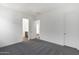 Bright bedroom featuring neutral carpet, white walls, and a view into the bathroom at 22670 E Happy Rd, Queen Creek, AZ 85142